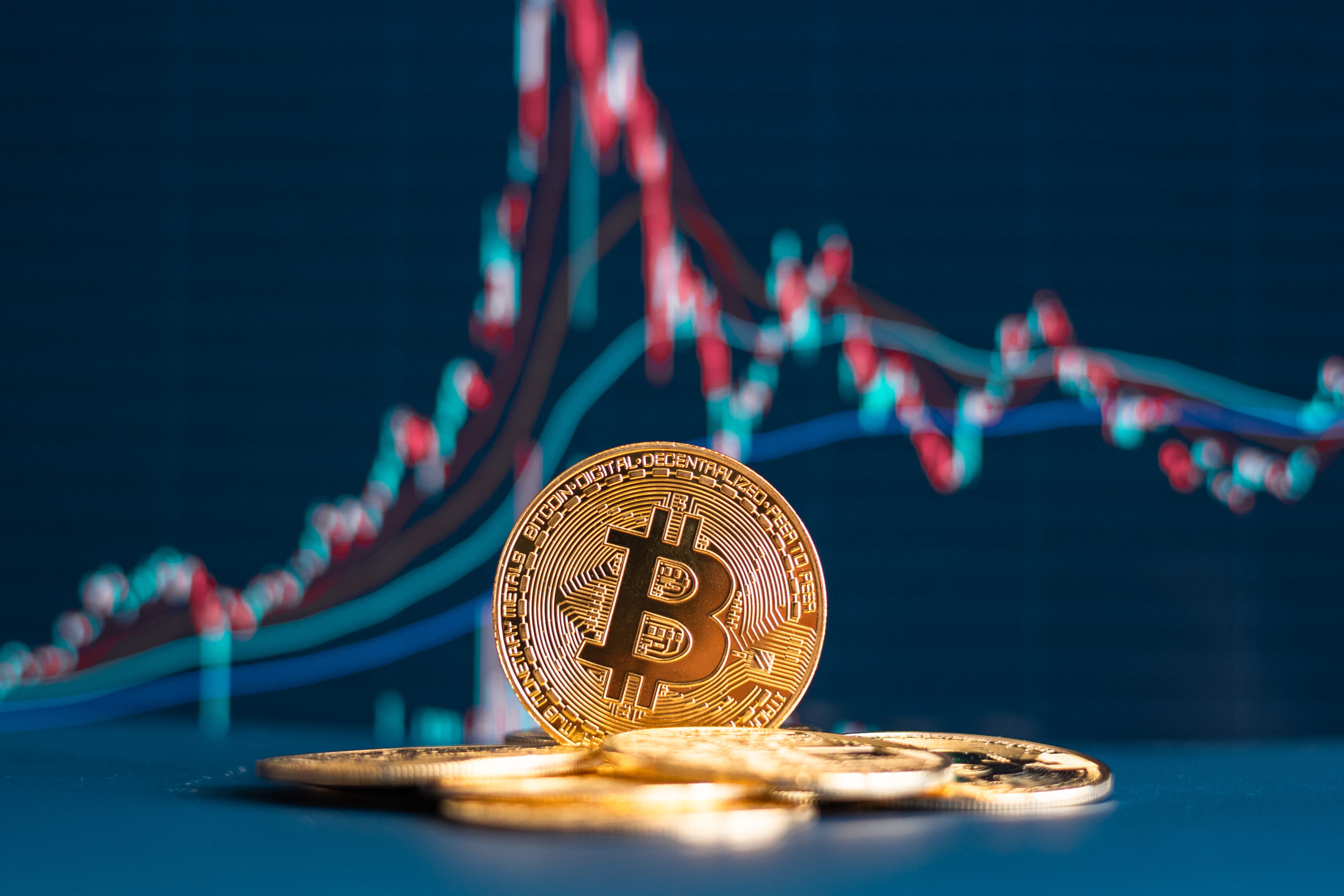 BTC coin with a dark blue financial market chart background