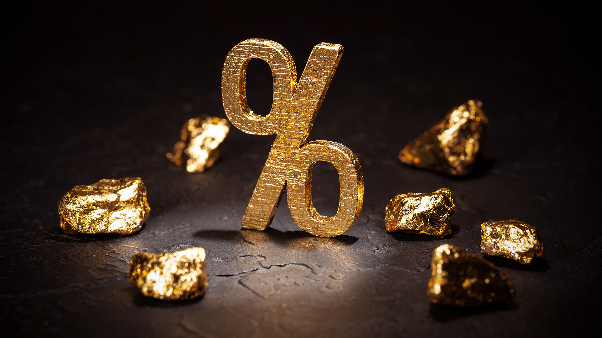 Percentage symbol in gold with gold nuggets amid Gold is Falling and the Markets Are Awaiting Interest Rates